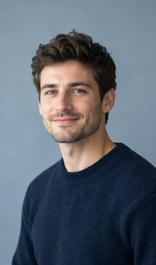 A candidate in a navy jumper smiling at the camera.