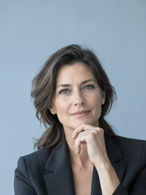 A hiring manager in a charcoal blazer, thinking.