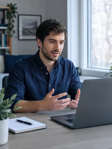 A candidate at a home desk on a video interview.
