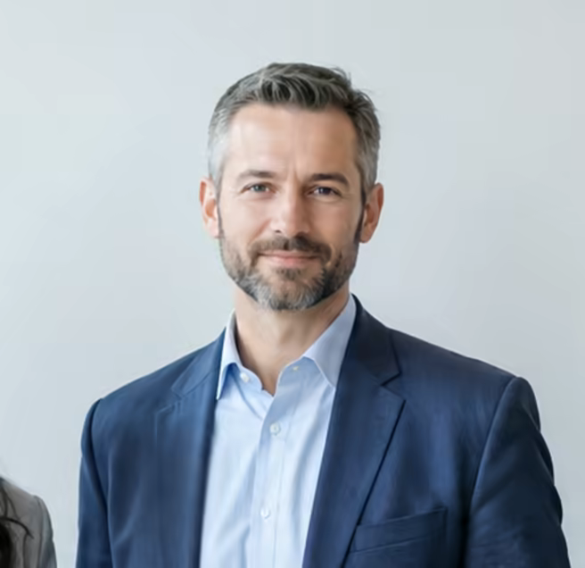 Tomas Lindqvist in a navy jacket and open collar.