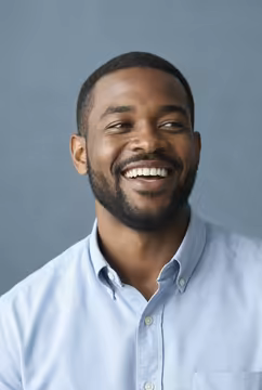 A candidate in a light blue shirt, laughing.