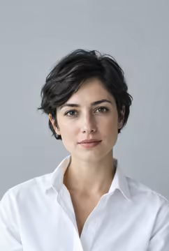 A candidate in a white shirt with a calm expression.